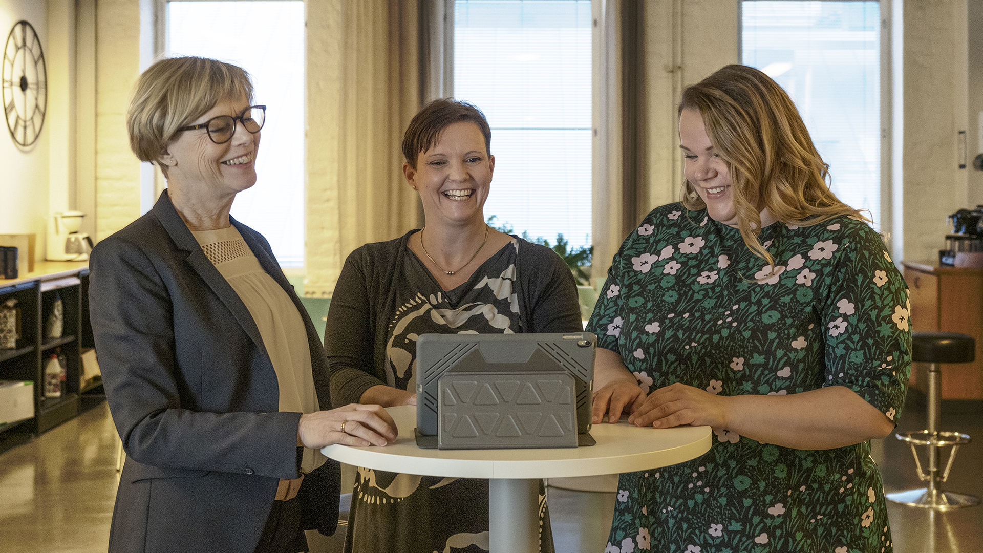 Experts of the Institute of Rehabilitation laughing around the table