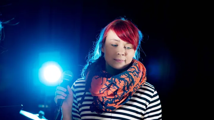 Girl singing on a stage