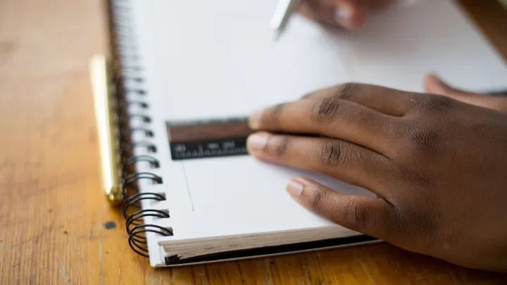 school student&#039;s hands holding a ruler on a notebook 