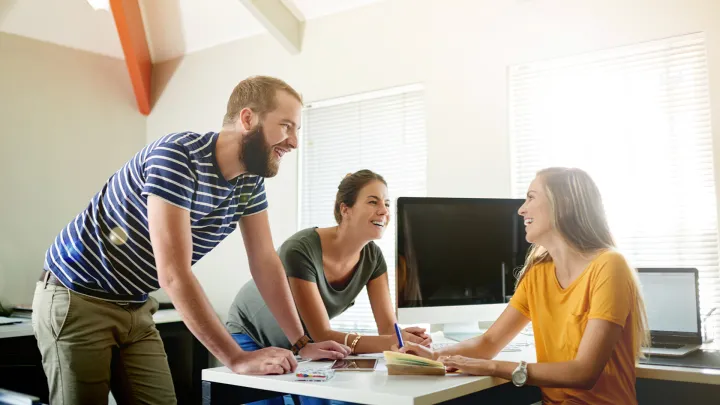 Three specialists around a table in office