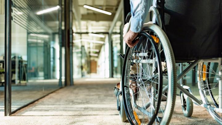 person in a wheelchair looking down the aisle